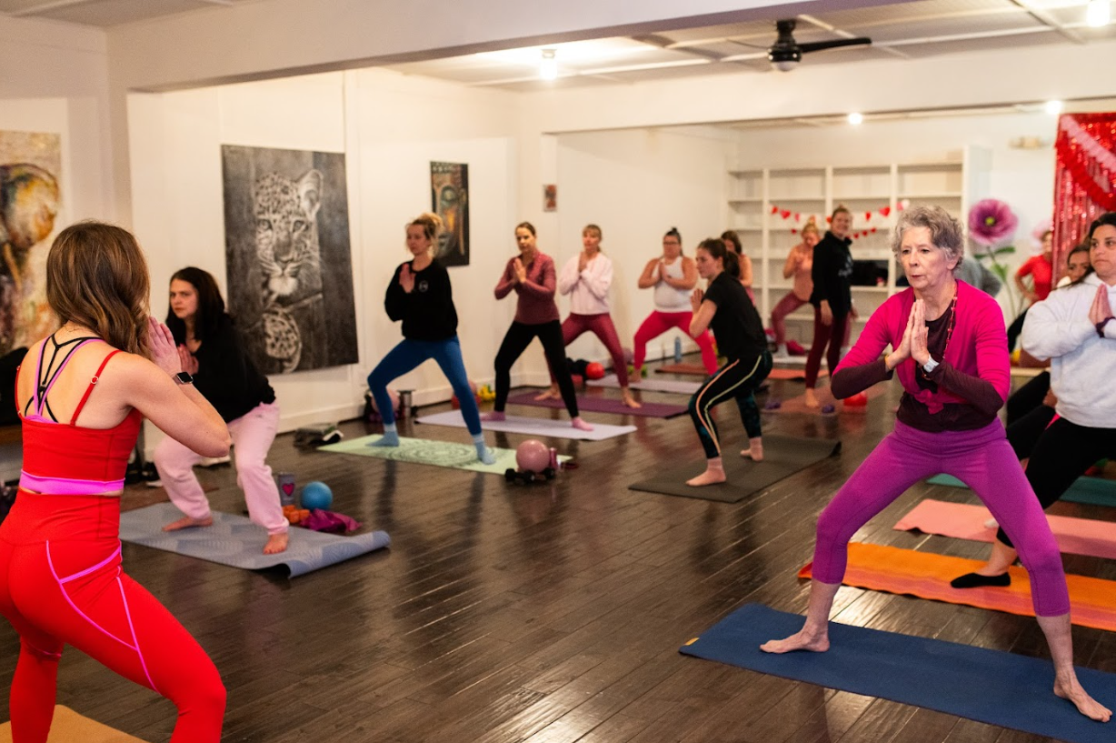 Hereford Barre students flowing through a balance pose during a class at the Parkton studio